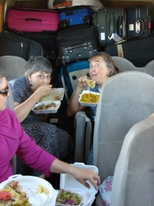 That's Kate and me in the back of the bus, eating our famous lunch of rice and lamb shanks with no utensils. Our job was to take care of the trash and hold up all those suitcases!