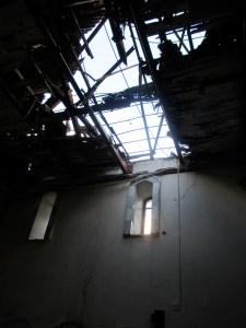 Cross-shaped hole in the roof of the National Evangelical (Presbyterian) Church of Homs, Syria.