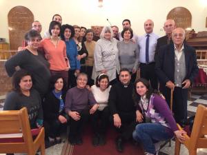 The Bloudan church elders and women's leaders on the chancel of the church. Assis Feras Ferah, who is pastoring the churches in Hasakeh, Kamishli and Malkieh in the northeast, is from this church. Many of these people are family to him. His mother is embraced by Marilyn Borst in the center.
